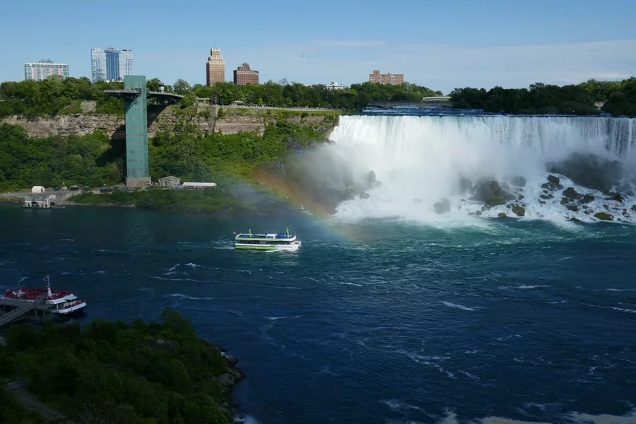 American Falls and Bridal Veil Falls viewed across the Niagara River with a rainbow in the mist